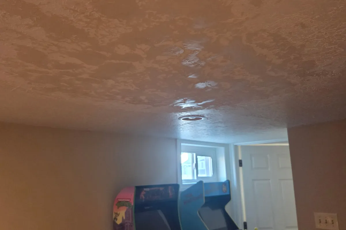 Freshly applied knockdown texture on a finished rec-room ceiling